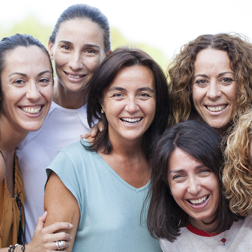 women gathered laughing and smiling together
