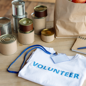 Volunteer materials and canned good laid on table