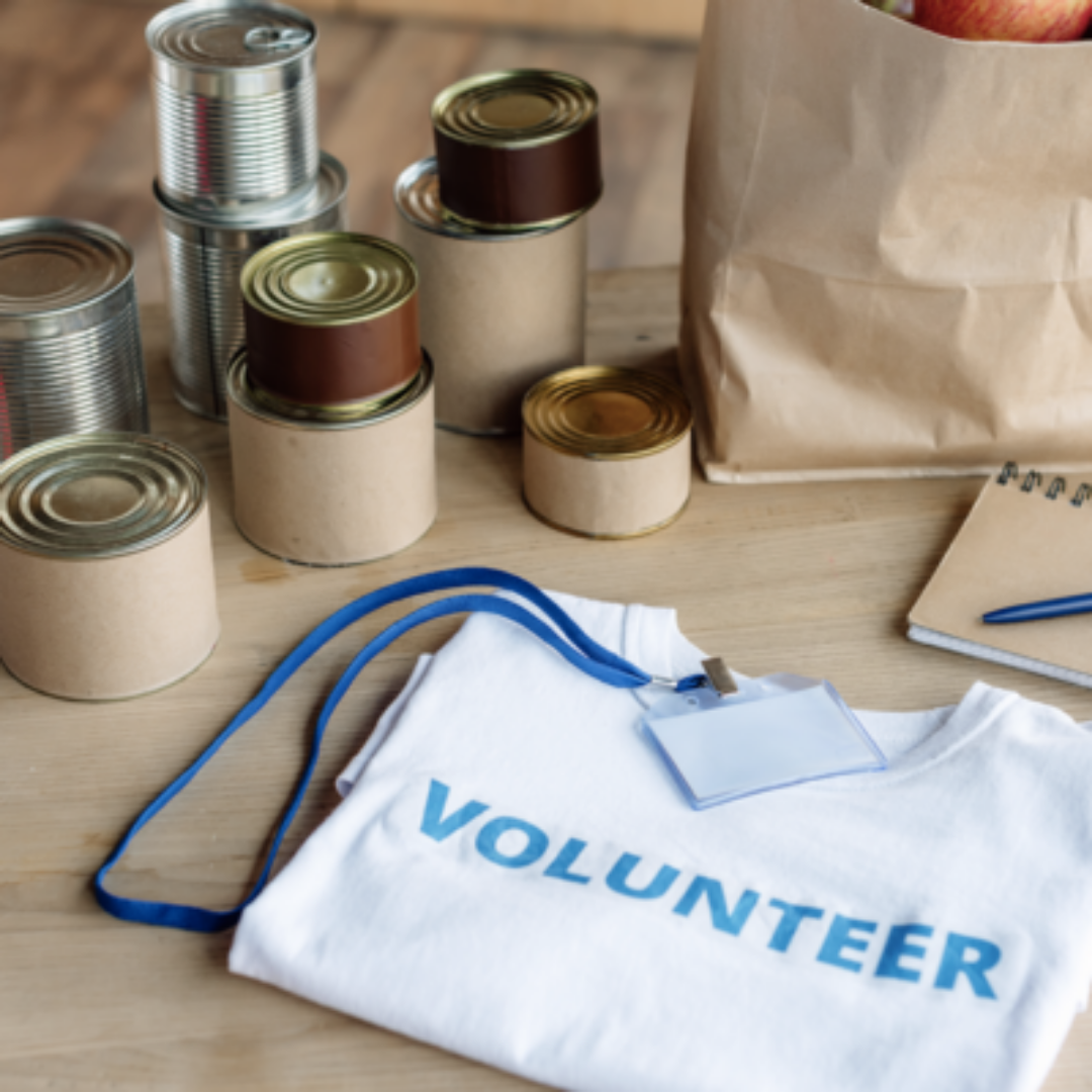 Volunteer materials and canned good laid on table